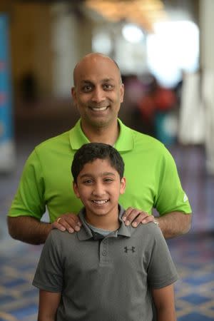 May 29, 2018; National Harbor, MD, USA; Atman Balakrishnan, 12, and his father Dr. Balu Natarajan of Chicago. Atman is competing in the 2018 Scripps National Spelling Bee at the Gaylord National Resort and Convention Center. Bali is a former contestant. Mandatory Credit: Sean Dougherty-USA TODAY NETWORK