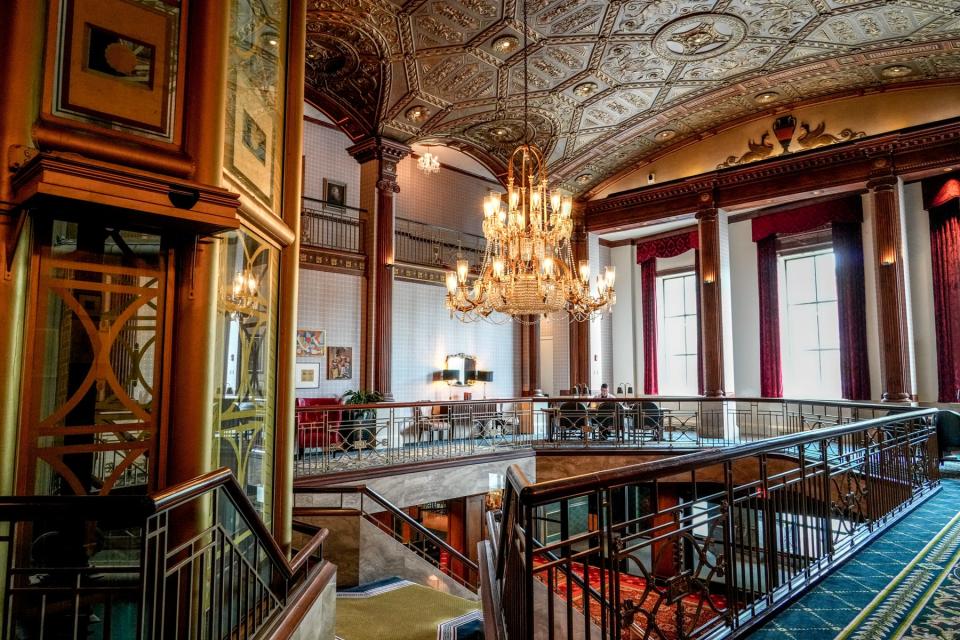 A second-floor view of the lobby and front entrance of the Graduate, decorated in the Beaux-arts style.