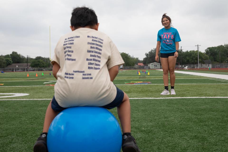 Premont Early College High School student Mikaela Vargas encourages a Special Olympics competitor forward on a bouncy ball, Wednesday, May 1, 2024, in Premont, Texas. Vargas is part of the Rural Schools Innovation Zone Grow Your Own Educator Academy.