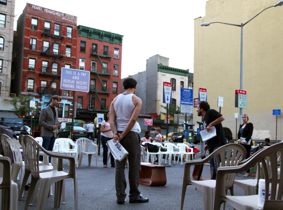 This July 29, 2013 photo shows actors rehearsing for "Richard III" in a parking lot in New York. Acting in one of Shakespeare's plays is difficult enough without having to dodge a 3,600-pound SUV. The bare-boned but enthusiastic summer production has as many as 77 plastic chairs that are placed in rows around a section of concrete that acts as the stage. If a car needs to get in or out, the actors pause and the patrons pick up their seats and make room. (AP Photo/Mark Kennedy)