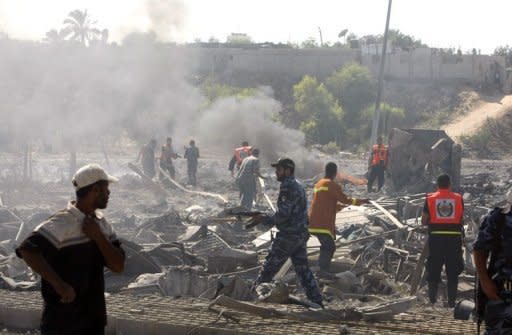 Palestinian firefighters extinguished a fire at the site of the local police station in Beit Lahia in the northern of Gaza Strip after an Israeli air strike. Gaza's Popular Resistance Committees agreed to halt to rocket fire on Israel and abide by an Egyptian-brokered truce after four days of deadly clashes