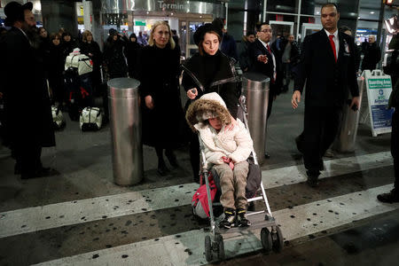 12-year-old Alma Kashkooli from Iran who has a severe medical condition, is wheeled out of Terminal 1 by her mother Farimeh Kashkooli who is living in the United States on a student Visa while studying at Fordham University Law School in New York, as Alma arrives at New York's John F. Kennedy International Airport in New York after traveling from Istanbul Turkey February 6, 2017. REUTERS/Mike Segar