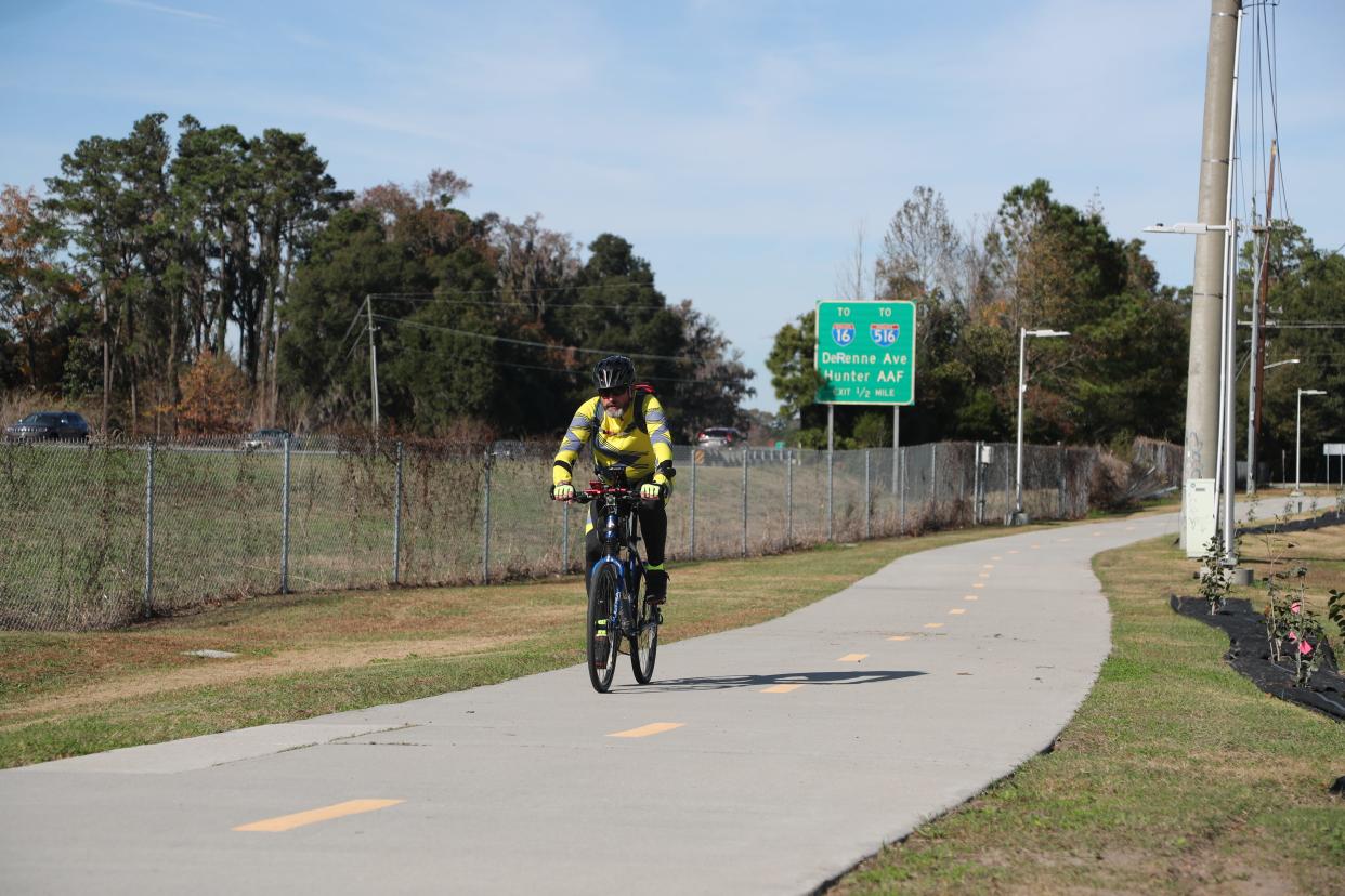 A bicycle rider cruises along the Truman Linear Trail on Tuesday, December 5, 2023.
