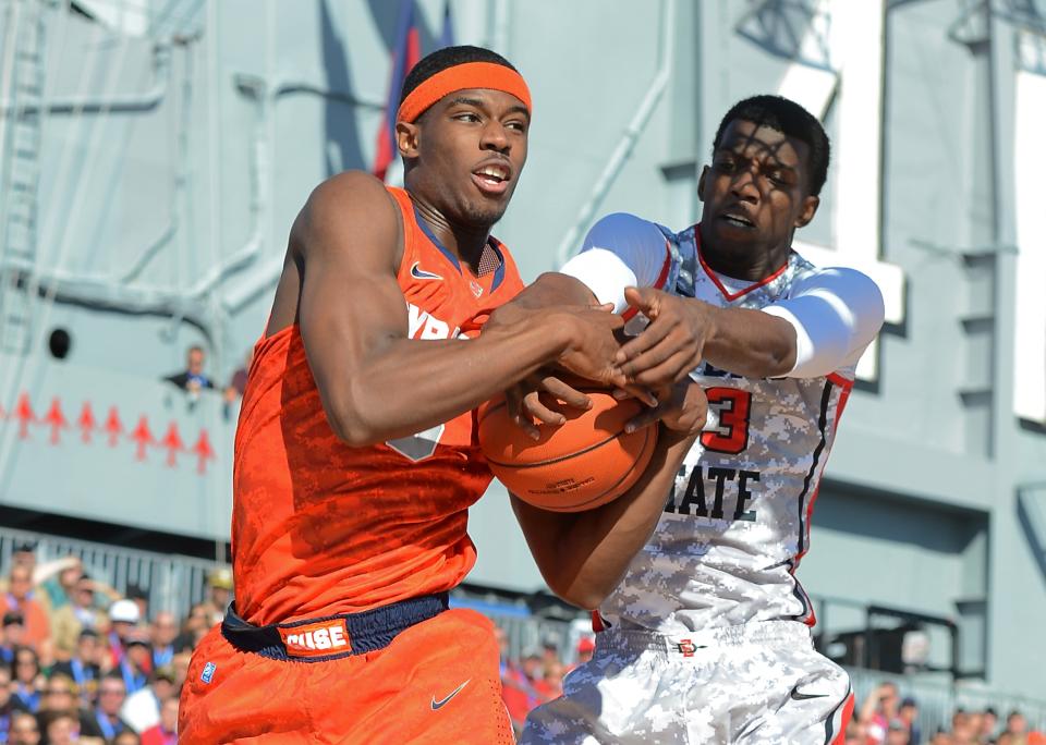 Jerami Grant #3 of the Syracuse Orange and Winston Shepard #13 of the San Diego State Aztecs vie for a rebound in the first half of the Battle On The Midway on board the USS Midway Aircraft Carrier on November 11, 2012 in San Diego, California. (Photo by Harry How/Getty Images)