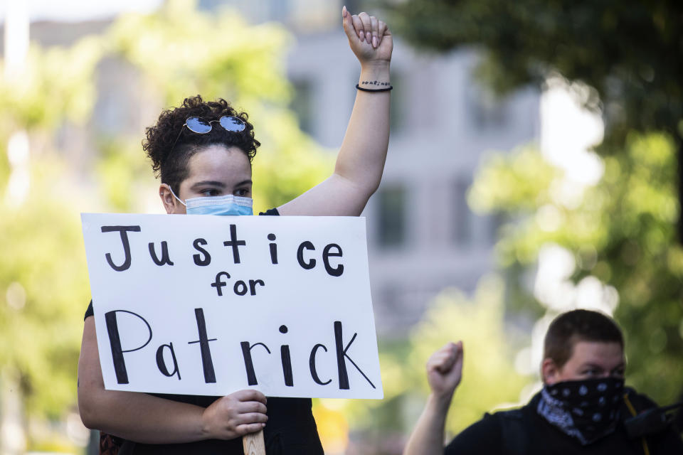 Mariah Arnold, 27, stands outside Grand Rapids Police Department after the Kent County Prosecutor announced second-degree murder charges against officer Christopher Schurr for the fatal shooting death of Patrick Lyoya in Grand Rapids, Mich. on Thursday, June 9, 2022. A prosecutor filed a second-degree murder charge Thursday against the Michigan police officer who killed Patrick Lyoya, a Black man who was on the ground when he was shot in the back of the head following an intense physical struggle recorded on a bystander's phone. (Joel Bissell/The Grand Rapids Press via AP)