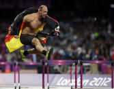 Germany's Robert Harting celebrates his gold medal win in the men's discus during the athletics in the Olympic Stadium at the 2012 Summer Olympics, London, Tuesday, Aug. 7, 2012. (AP Photo/Matt Slocum)