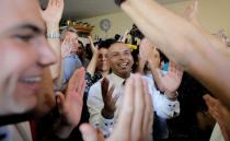 Groom Mahmoud Mansour, 26, (C) celebrates with friends and family before his wedding to bride Maral Malka, 23, in Jaffa, south of Tel Aviv August 17, 2014. Israeli police on Sunday blocked more than 200 far-right Israeli protesters from rushing guests at the wedding of a Jewish woman and Muslim man as they shouted "death to the Arabs" in a sign of tensions stoked by the Gaza war. Picture taken August 17, 2014. To match MIDEAST-ISRAEL/WEDDING REUTERS/Ammar Awad