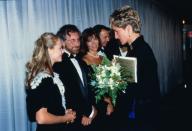 <p>At the London premiere of <em>Jurassic Park, </em>actress Ariana Richards wore a short sleeve black dress with a white lace bib. Director Steven Spielberg stands next to her, waiting for his turn to meet the Princess.</p>