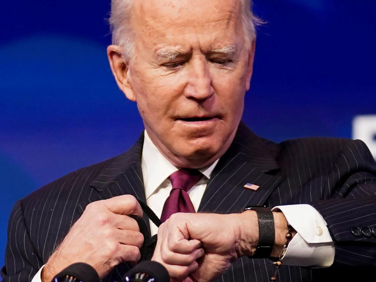 <p>President-elect Joe Biden looks at his watch as he arrives to announce former South Bend, Indiana Mayor Pete Buttigieg as his nominee for secretary of transportation during a news conference at Biden’s transition headquarters in Wilmington, Delaware on 16 December 2020</p> ((Reuters))