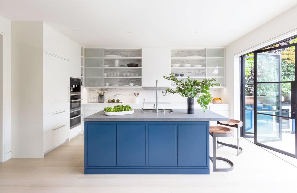 <p>Rather than only introducing color through accents like dishes and cookware, pick a statement piece, and don't be afraid to be bold. Here, Heather Hilliard chose a soft, deep blue hue for the kitchen island base. It's bold, but still minimalist. </p>