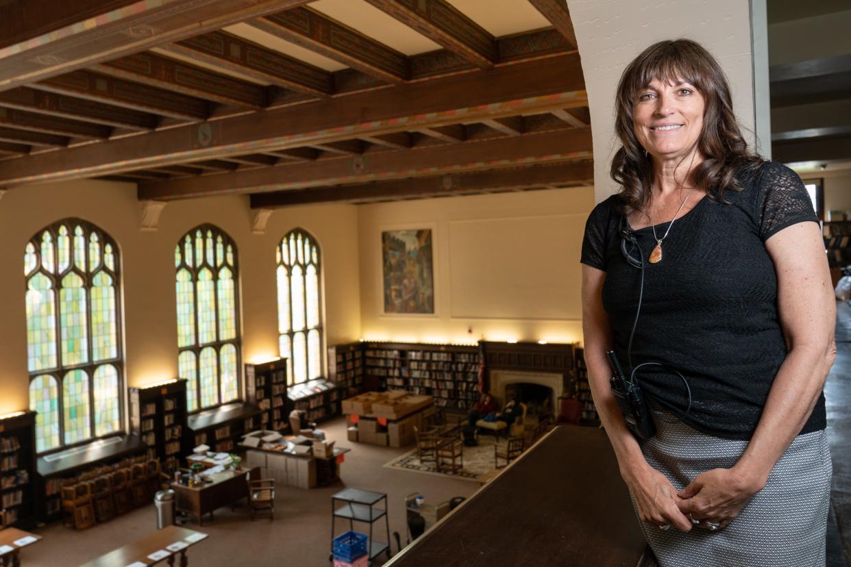 Topeka High principal Rebecca Morrisey smiles from the loft of the historic library at the school, her favorite spot, that she's overseen for the past seven years on May 23.