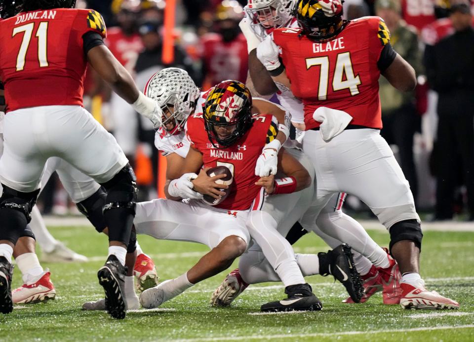 Nov 19, 2022; College Park, MD, USA; Ohio State Buckeyes defensive end J.T. Tuimoloau (44) tackles Maryland Terrapins quarterback Taulia Tagovailoa (3) for a sack in the second quarter of their Big Ten game at SECU Stadium. 