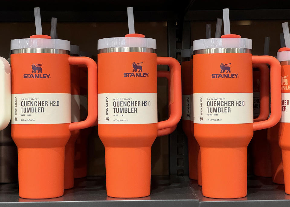 Several Stanley Quencher H2.0 Tumblers with lids and straws are displayed on a store shelf