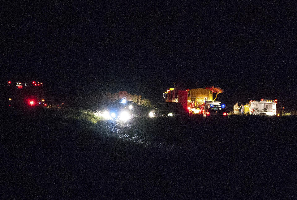 This Wednesday, Feb. 26, 2014 photo released by Russell deJetley shows emergency crews at the site of a plane crash in Lanai City, Hawaii. A small plane crashed and burst into flames shortly after takeoff from Hawaii's Lanai island, killing three people and leaving three others injured, authorities said Thursday. The crash occurred around 9:30 p.m. Wednesday about a mile from Lanai Airport in the Miki Basin area, Maui County spokesman Rod Antone told The Associated Press. (AP Photo/Russell deJetley)