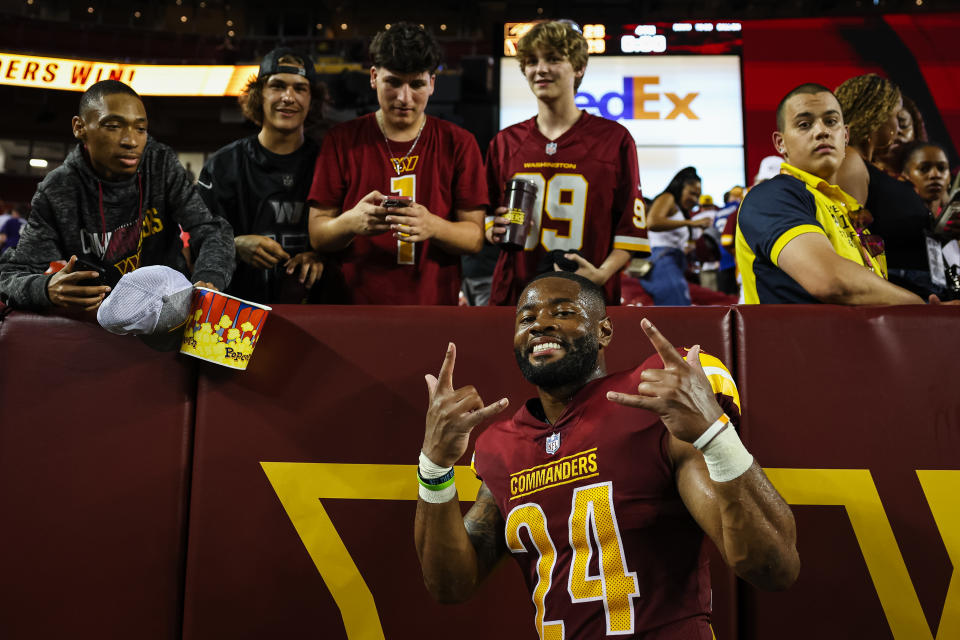 Terrell Burgess #24 of the Washington Commanders interacts with fans. (Photo by Scott Taetsch/Getty Images)