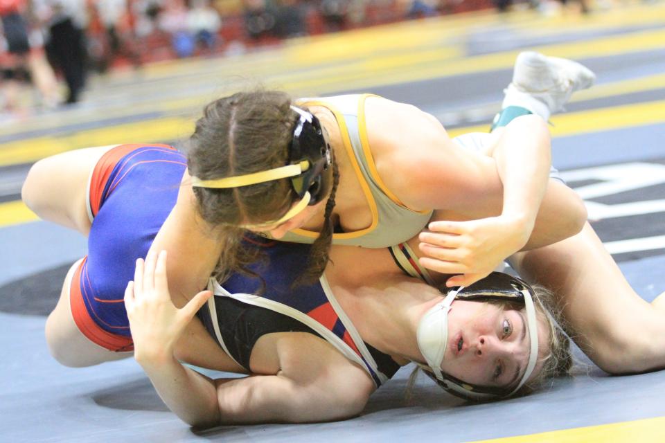 Licking Valley's Addison Justice wrestles Kettering Alter's Alora Strauser in a 125-pound match during the girls state championships at Ohio State's Schottenstein Center on Saturday, March 9, 2024.