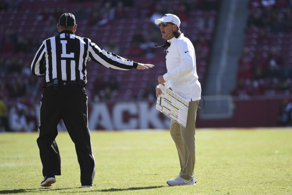 Arkansas coach Chad Morris talks with an official while playing Western Kentucky during the second half of an NCAA college football game, Saturday, Nov. 9, 2019 in Fayetteville, Ark. (AP Photo/Michael Woods)