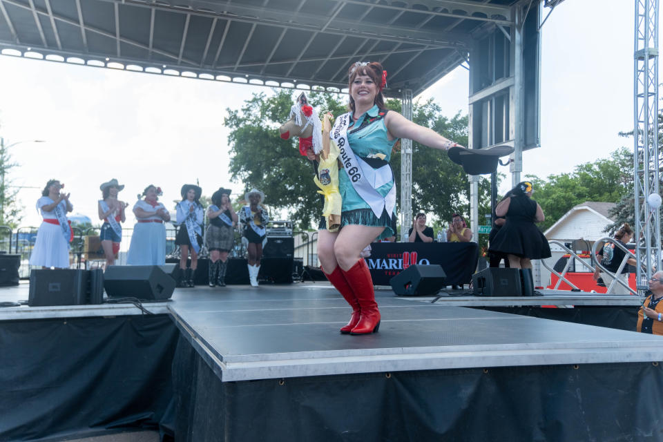 The Route 66 pinup Pageant winner bows to the crowd at the Amarillo National Bank Route 66 Celebration in Amarillo.