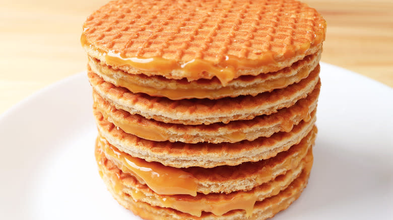 Stroopwafels stacked on white plate