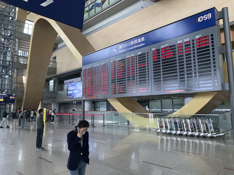 Screens display cancelled China Eastern Airline flights at Kunming Changshui International Airport, Tuesday, March 22, 2022, in Kunming in southwest China’s Yunnan province. No survivors have been found among the 132 people onboard a China Eastern Boeing 737-800 that departed from Kunming and crashed Monday in the southern province of Guangxi. As family members gathered at the destination and departure airports, what caused the crash remains a mystery. (AP Photo/Dake Kang)