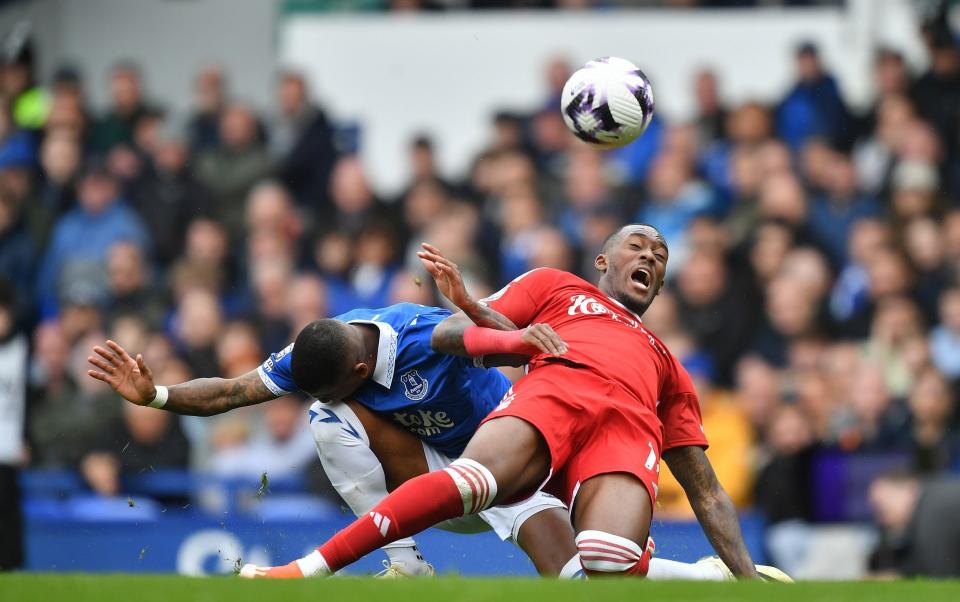 Nottingham Forest winger Callum Hudson-Odoi goes down under challenge from Ashley Young