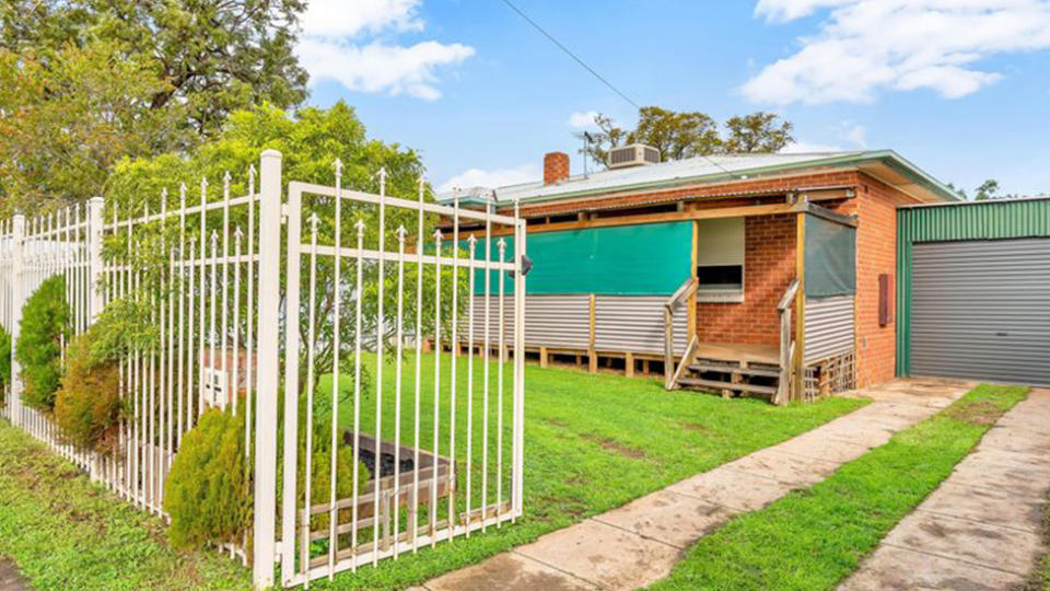 Photo shows the front of the house, with the front garden and entertaining area.