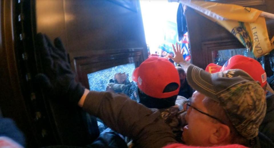 A video allegedly filmed by James D. Rahm III of Atlantic City shows rioters trying to force their way through a door during the U.S. Capitol riot on Jan. 6, 2021.