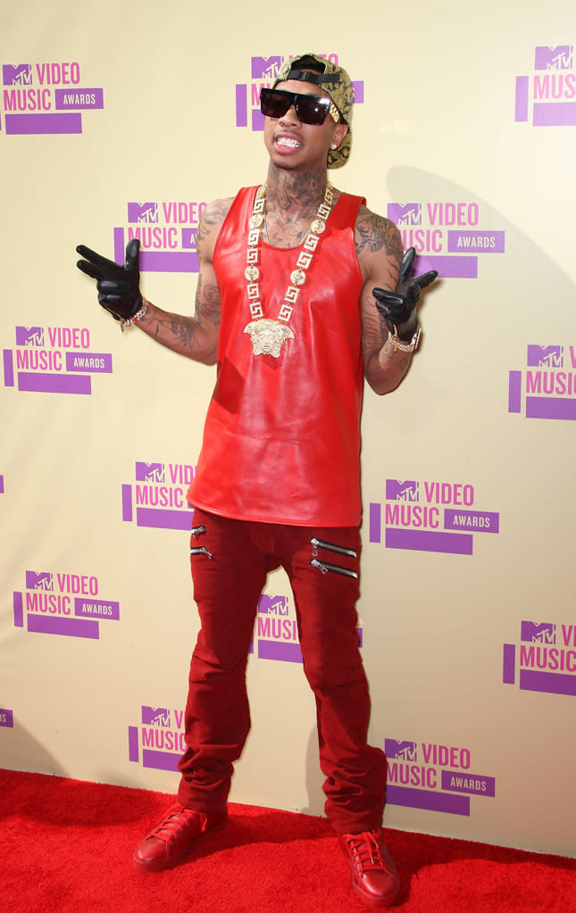 Hip-hop artist Tygga (real name: the less catchy Michael Ray Nguyen-Stevenson) showed off his many tats in a red tank, which he paired with red pants and sneaks. Black leather gloves and a chunky gold medallion rounded out the flashy getup.