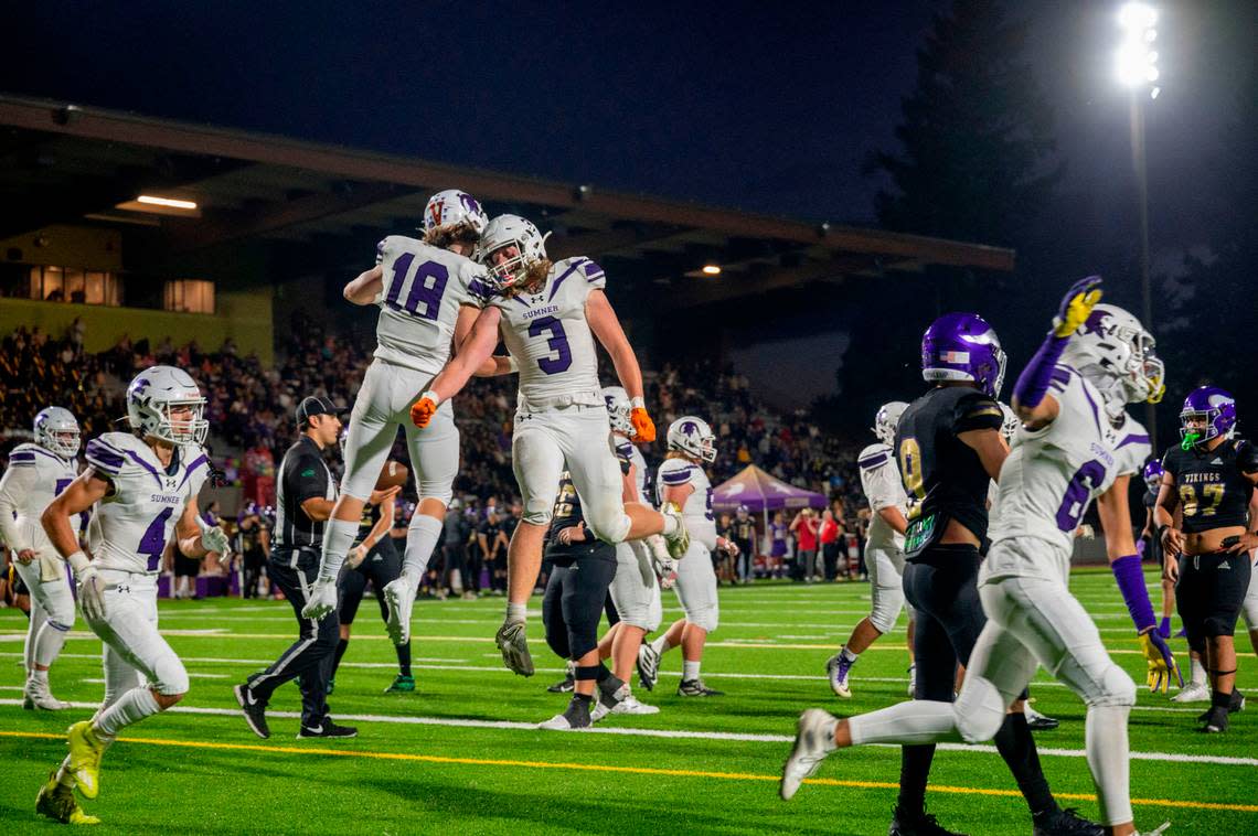 Sumner’s Kaden Malesis (18) celebrates with Austin Cook after Malesis caught a touchdown pass from quarterback Kaden Bodine during the second quarter of a 4A SPSL game against Puyallup on Friday, Sept. 23, 2022, at Sparks Stadium in Puyallup, Wash.