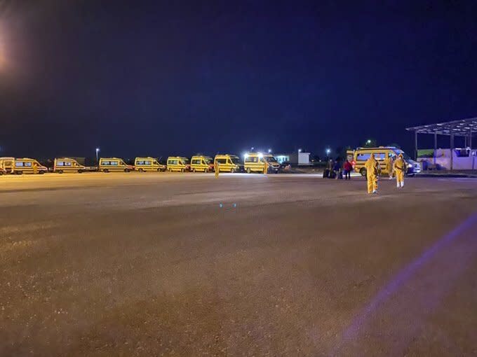 In this photo provided by Matt Swider, posted on Twitter on March 9, 2020, a convoy of ambulances awaits tourists who were evacuated from the souther city of Luxor to take them to quarantine facility, at a remote airport near the north coast city of Marsa Matrouh, Egypt. Swider, an American tourist, has been confined there since he tested positive for the new coronavirus after a Nile cruise in southern Egypt. For most people, the new coronavirus causes only mild or moderate symptoms. For some it can cause more severe illness. (Matt Swider via AP)