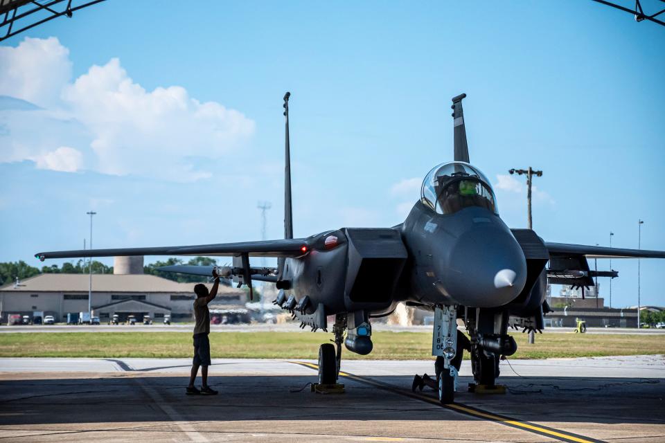 A maintenance support contractor checks the AIM-120D3 attached to an F-15E Strike Eagle as it prepares for a live-fire mission at Eglin Air Force Base on June 30.