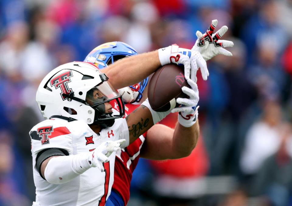 Texas Tech defensive back Dadrion Taylor-Demerson (1) of intercepts a pass intended for Kansas tight end Jared Casey (47) during the Big 12 football game, Saturday, Nov. 11, 2023, at David Booth Kansas Memorial Stadium in Lawrence, Kansas.