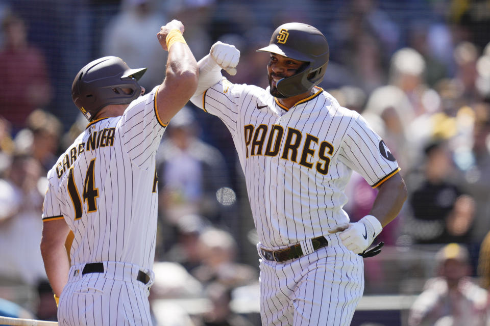 San Diego Padres' Xander Bogaerts, right, celebrates with teammate Matt Carpenter after hitting a two-run home run during the fifth inning of a baseball game against the Arizona Diamondbacks, Tuesday, April 4, 2023, in San Diego. (AP Photo/Gregory Bull)