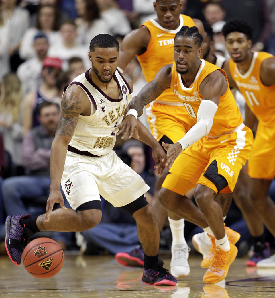 Texas A&M guard TJ Starks, left, recovers the ball in front of Tennessee guard Jordan Bone (0) during the first half of an NCAA college basketball game Saturday, Feb. 2, 2019, in College Station, Texas. (AP Photo/Michael Wyke)