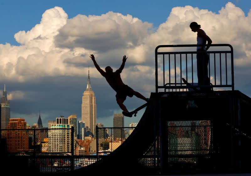 skateboarding in front of the empire state building in new york city