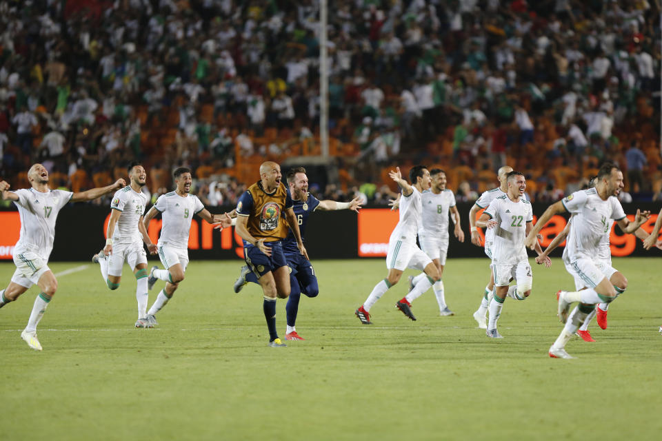 Algerian players celebrate after the African Cup of Nations semifinal soccer match between Algeria and Nigeria in Cairo International stadium in Cairo, Egypt, Sunday, July 14, 2019. (AP Photo/Amr Nabil)