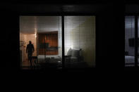 Seth Robinson, a chiropractor who serves as Tesla BioHealing's medical director, closes down an empty room after a tour at Tesla Wellness Hotel and MedBed Center on Tuesday, Nov. 14, 2023, in Butler, Pa. A one-night stay at the Tesla complex runs $450. A small canister retails for $599, with versions marketed for children or pets going for a little less. (AP Photo/Carolyn Kaster)