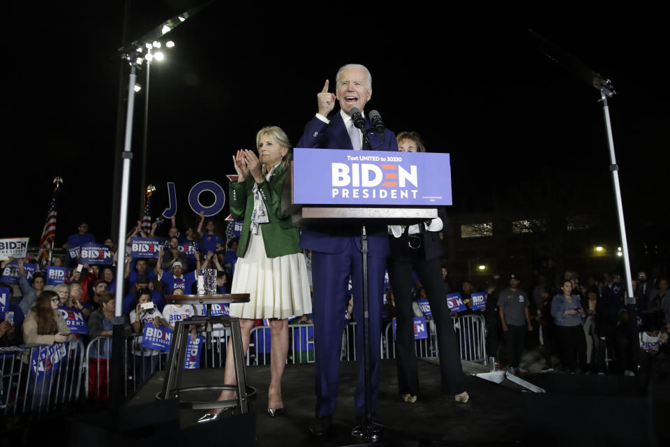 Democratic presidential candidate former Vice President Joe Biden speaks, next to his wife Jill during a primary election night rally Tuesday, March 3, 2020, in Los Angeles. (AP Photo/Marcio Jose Sanchez)