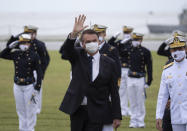 Brazilian President Jair Bolsonaro greets those gathered for a graduation ceremony at the Naval Academy, in Rio de Janeiro, Brazil, Saturday, June 19, 2021, amid the COVID-19 pandemic. People gathered across the country Saturday, to protest Bolsonaro's handling of the pandemic and economic policies protesters say harm the interests of the poor and working class. (AP Photo/Silvia Izquierdo)