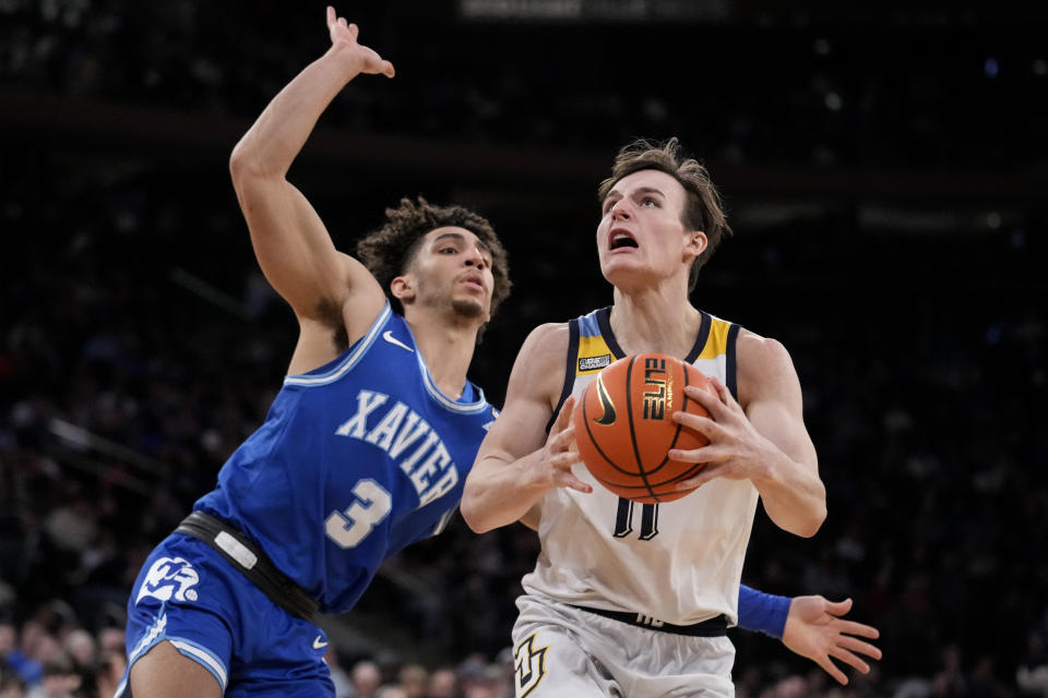 Marquette's Tyler Kolek (11) shoots against Xavier's Colby Jones (3) in the second half of an NCAA college basketball game for the championship of the Big East men's tournament, Saturday, March 11, 2023, in New York. (AP Photo/John Minchillo)