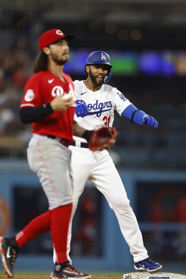LOS ANGELES, CALIFORNIA - JULY 28: Amed Rosario #31 of the Los Angeles Dodgers doubles against the Cincinnati Reds.