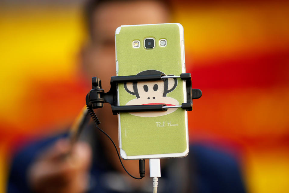 <p>A man takes pictures of himself as people gather in Tiananmen Square to celebrate National Day marking the 67th anniversary of the founding of the People’s Republic of China, in Beijing October 1, 2016. (REUTERS/Damir Sagolj) </p>