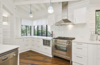 <p>The kitchen has a lot fo natural light and features a new chef's stove with range-hood.</p>