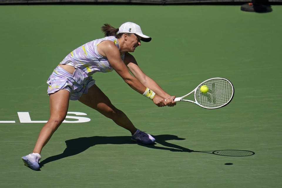 Iga Swiatek, of Poland, return a shot to Maria Sakkari, of Greece, during the women's singles finals at the BNP Paribas Open tennis tournament Sunday, March 20, 2022, in Indian Wells, Calif. (AP Photo/Marcio Jose Sanchez)