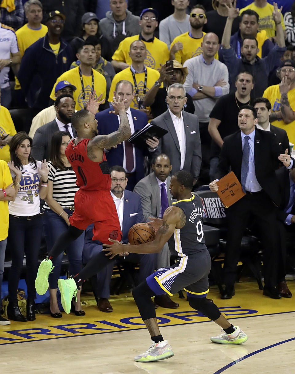 Golden State Warriors' Andre Iguodala, right, strips the ball from Portland Trail Blazers' Damian Lillard during the final seconds of Game 2 of the NBA basketball playoffs Western Conference finals Thursday, May 16, 2019, in Oakland, Calif. The Warriors won 114-111. (AP Photo/Ben Margot)