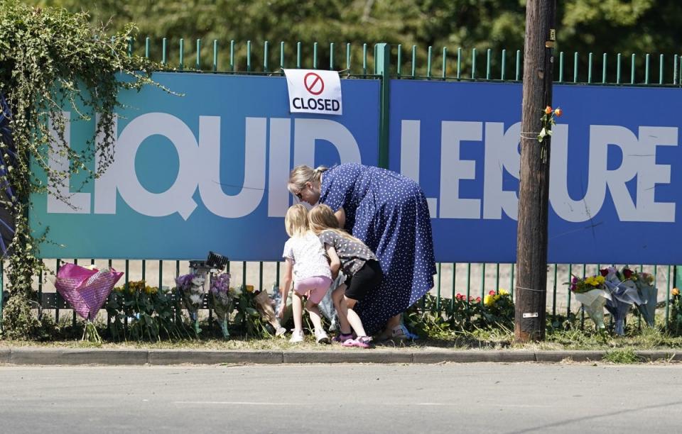 People leave flowers outside Liquid Leisure in Windsor. (PA) (PA Wire)