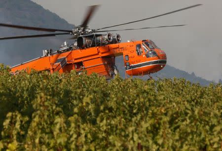 Firefighting helicopters work to contain a wildfire near Oakville, California, U.S., October 16, 2017. REUTERS/Jim Urquhart