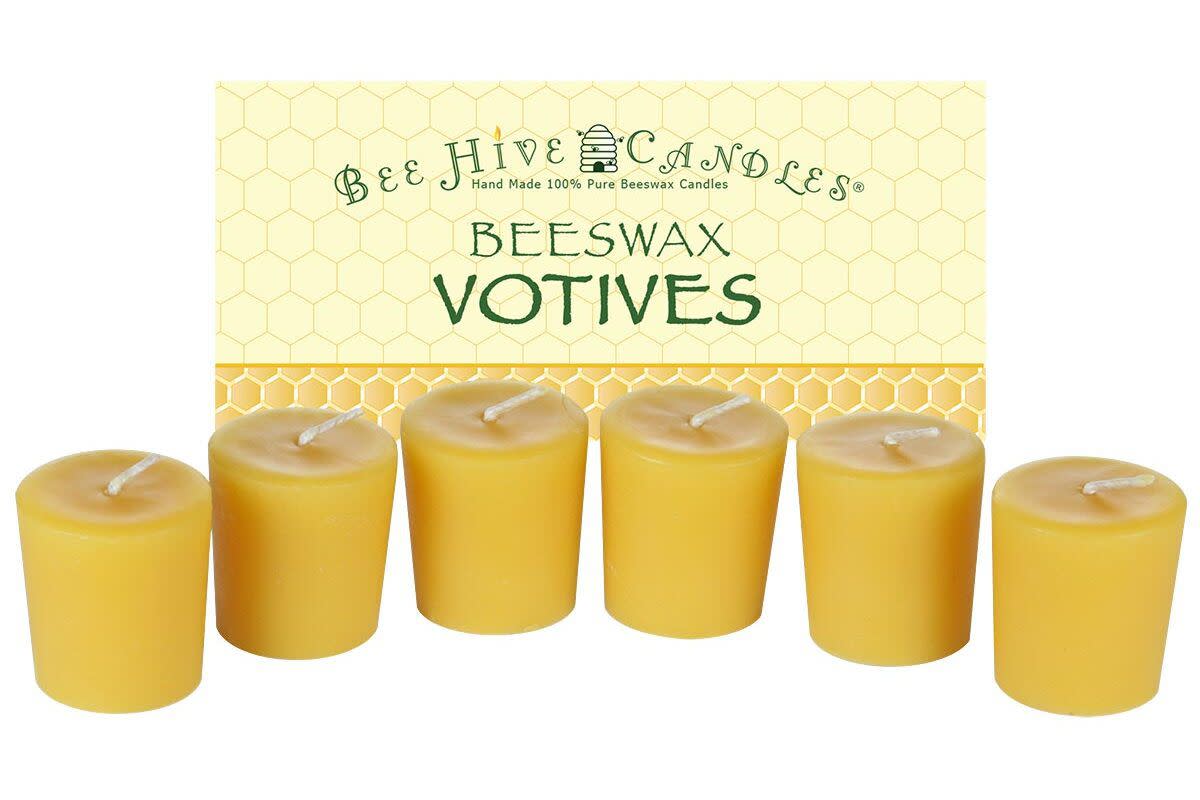Six yellow Bee Hive beeswax votive candles.