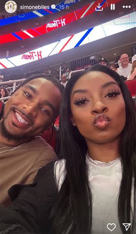 <p>Simone Biles/Instagram</p> Simone Biles poses for a selfie with husband Jonathan Owens while watching the Houston Rockets in April 2024.