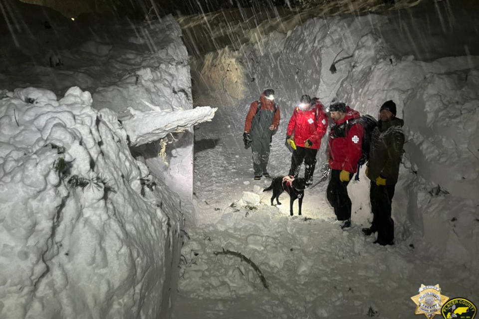 ADDS PALISADES SKI PATROL In this photo provided by the Placer County Sheriff's Office is a Tahoe Nordic Search and Rescue crew and Palisades Ski Patrol who assisted with evacuation efforts and used their K-9s to search for potential victims after a three-story apartment building was hit with an avalanche in Olympic Valley, Calif., Tuesday, Feb. 28, 2023. All occupants were uninjured and able to evacuate the building with help from fire crews. The avalanche was approximately 200 yards wide and 25 feet deep and engulfed the bottom two stories of the building. (Placer County Sheriff's Office via AP)